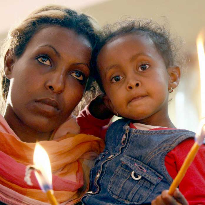 Mom and little girl with candles